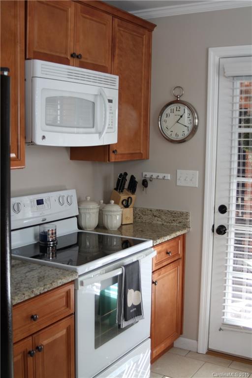 402 Stowe Road Belmont, NC 28012 - Photo 5 of 8 a kitchen with stainless steel appliances granite countertop a stove a microwave and cabinets