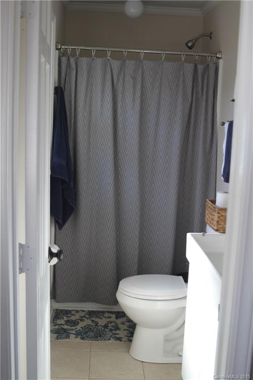 402 Stowe Road Belmont, NC 28012 - Photo 8 of 8 a white toilet sitting next to a shower curtain