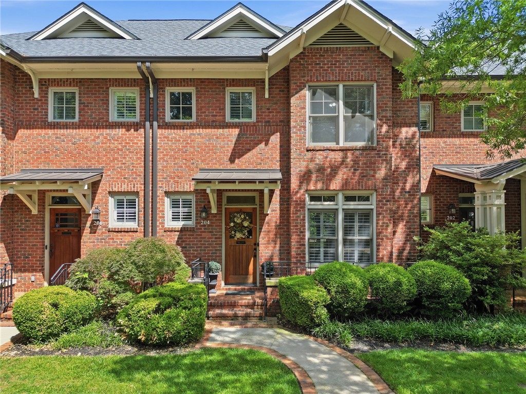 204 Butler Avenue Greenville, SC 29601 - Photo 1 of 26 A classic brick townhouse with mature landscaping offers inviting curb appeal.