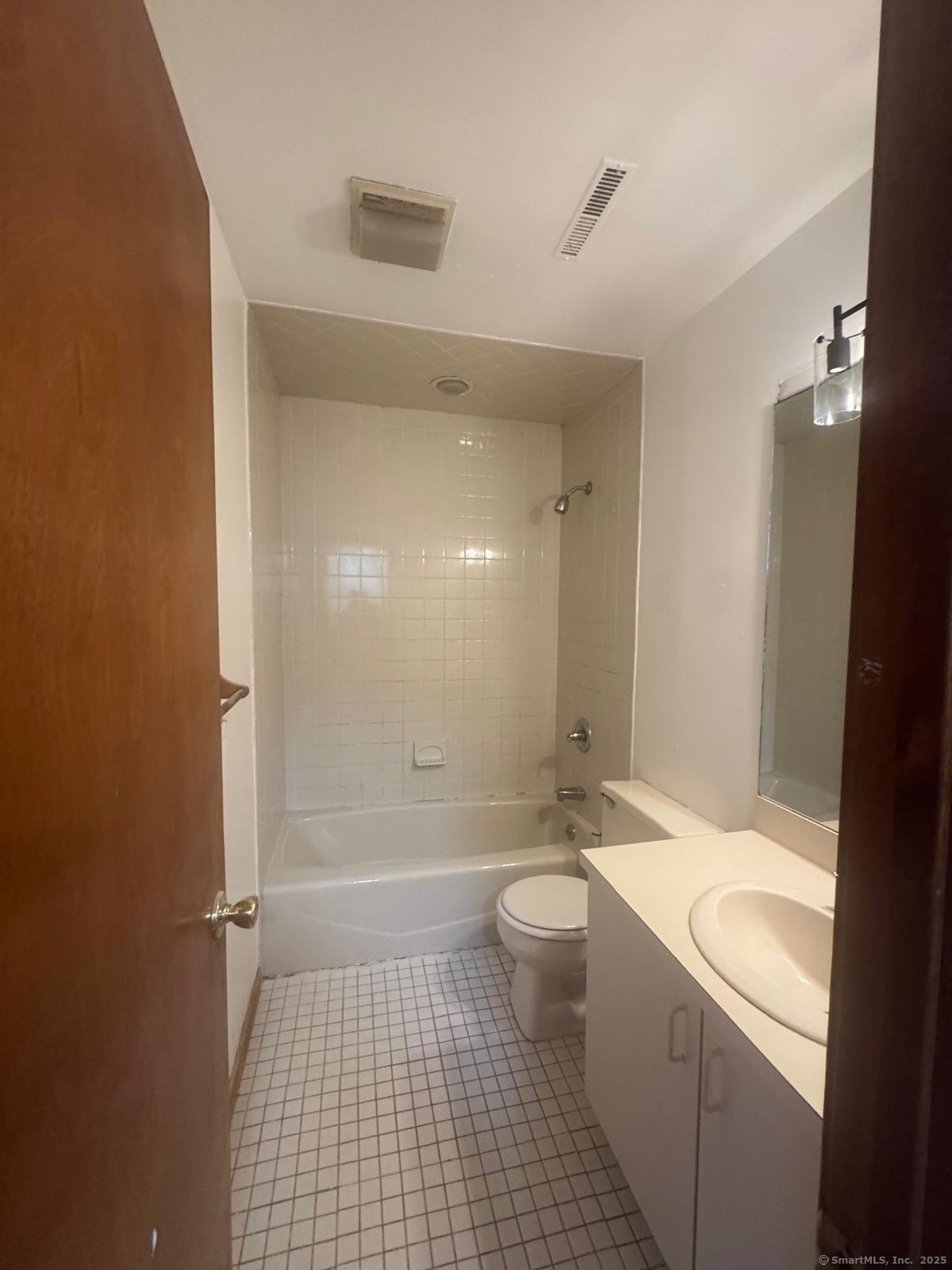 204 Wheeler Avenue, Unit 6 Bridgeport, CT 06606 - Photo 13 of 15 a bathroom with a sink a toilet and shower