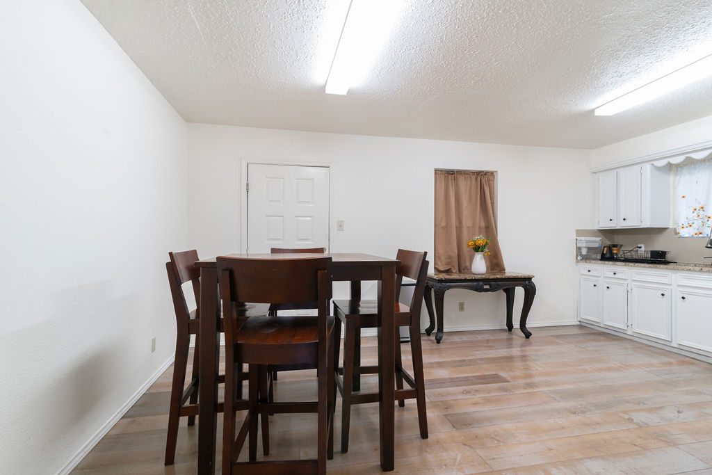 1106 Saucedo Street Austin, TX 78721 - Photo 12 of 34 Dining space featuring light wood-type flooring and a textured ceiling