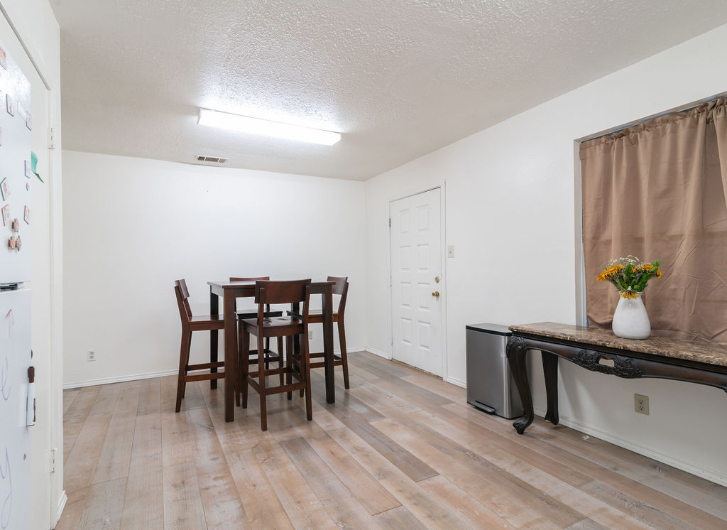 1106 Saucedo Street Austin, TX 78721 - Photo 16 of 34 Dining space in kitchen featuring light wood-type flooring and a textured ceiling