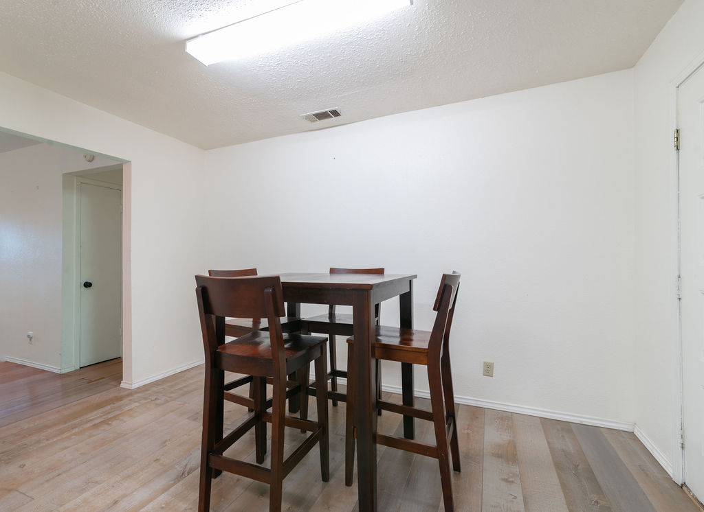 1106 Saucedo Street Austin, TX 78721 - Photo 17 of 34 Dining area in kitchen with light wood-style flooring and a textured ceiling