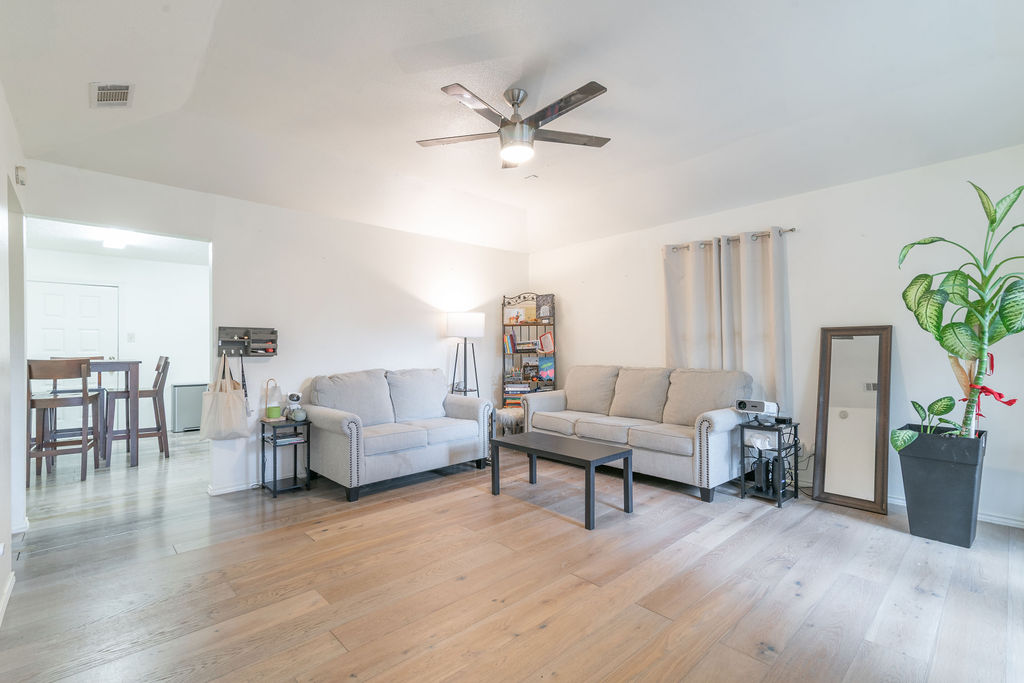 1106 Saucedo Street Austin, TX 78721 - Photo 2 of 34 Living room with a ceiling fan and light wood-type flooring
