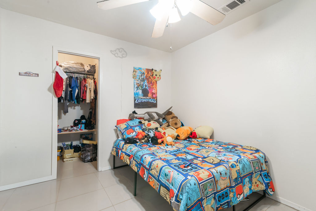1106 Saucedo Street Austin, TX 78721 - Photo 23 of 34 Tiled bedroom with ceiling fan and baseboards