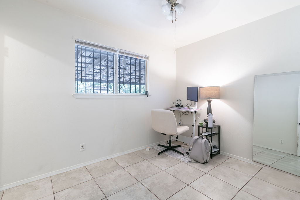 1106 Saucedo Street Austin, TX 78721 - Photo 24 of 34 Tiled office space with a ceiling fan and baseboards