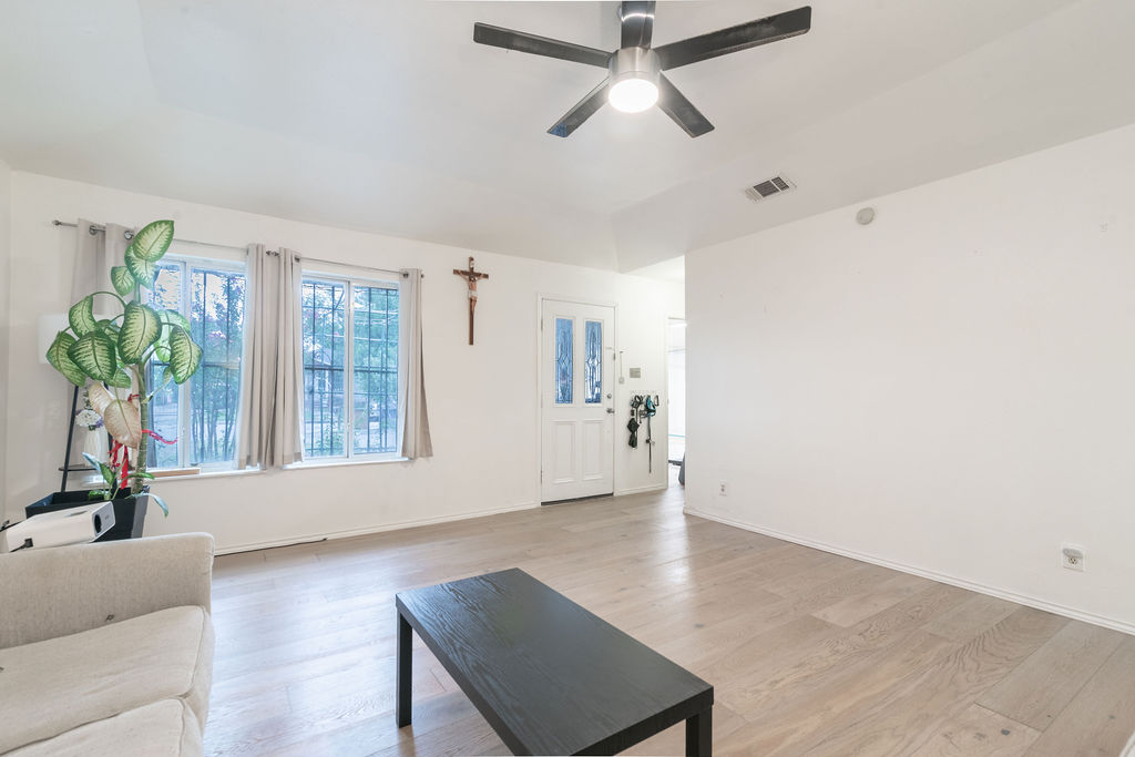 1106 Saucedo Street Austin, TX 78721 - Photo 5 of 34 Living room featuring light wood finished floors and a ceiling fan