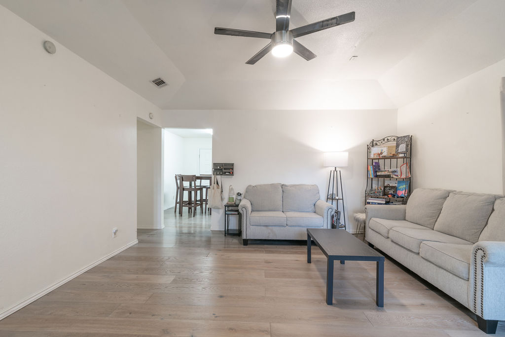 1106 Saucedo Street Austin, TX 78721 - Photo 6 of 34 Living room with ceiling fan and light wood finished floors