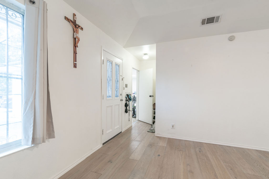 1106 Saucedo Street Austin, TX 78721 - Photo 7 of 34 Spare room with light wood-style floors and vaulted ceiling