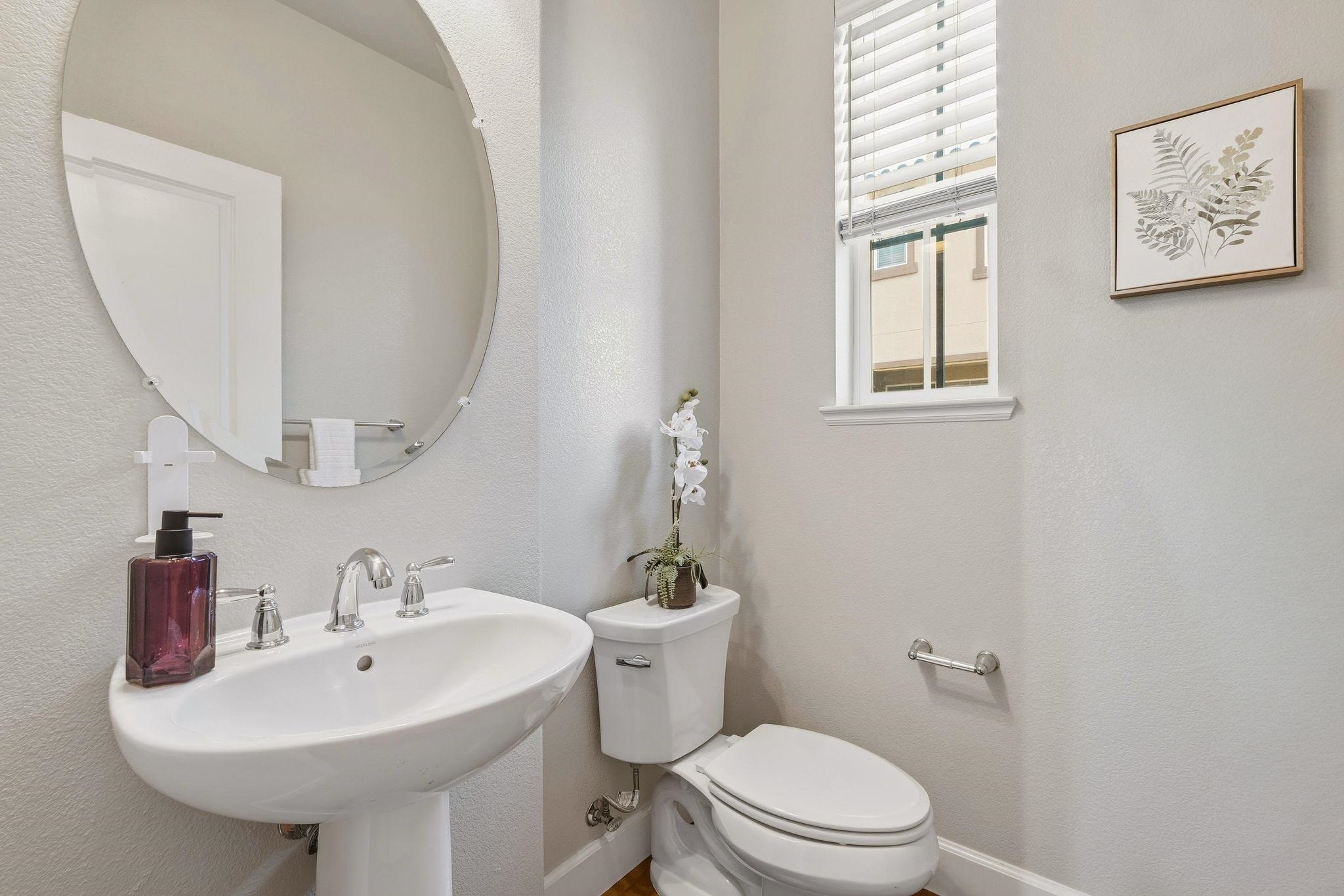 2863 Finca Terrace Fremont, CA 94539 - Photo 23 of 37 a bathroom with a sink a mirror and a toilet
