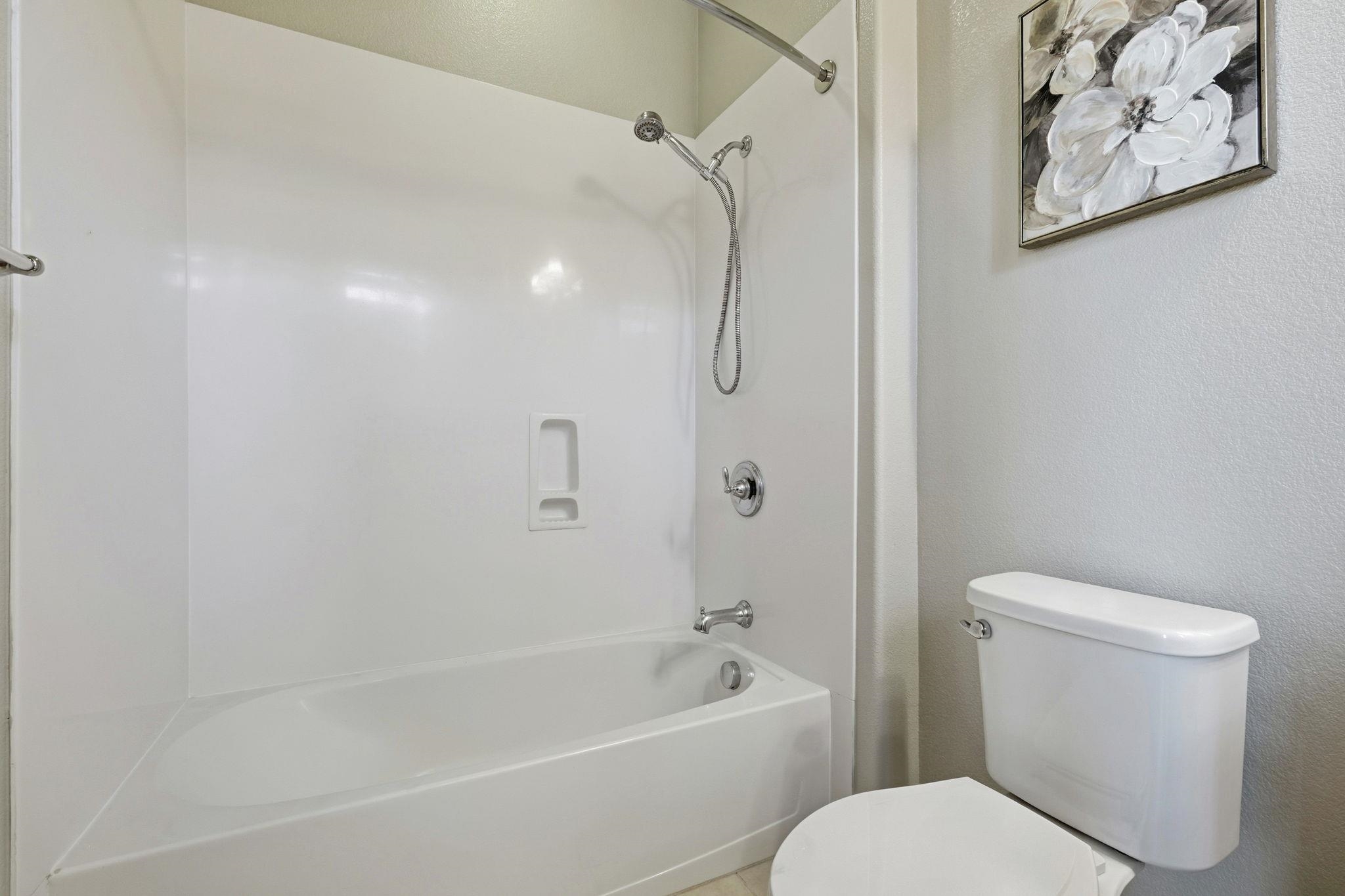 2863 Finca Terrace Fremont, CA 94539 - Photo 25 of 37 a white toilet sitting next to a bath tub and a shower