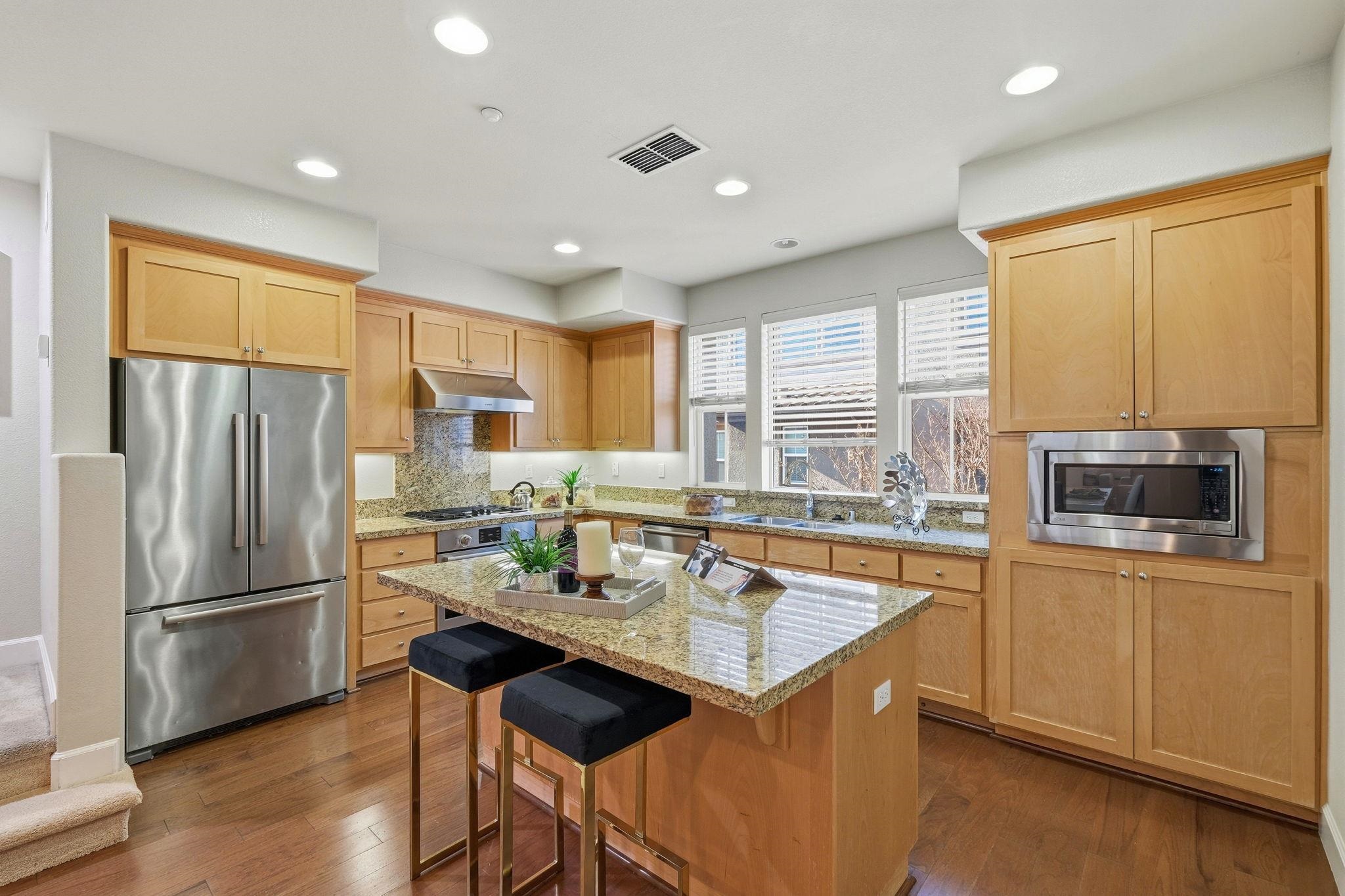 2863 Finca Terrace Fremont, CA 94539 - Photo 9 of 37 a kitchen with granite countertop a refrigerator stove top oven and sink