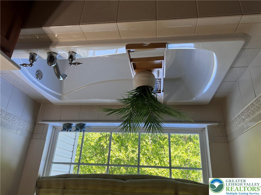 8549 Gateway Road Breinigsville, PA 18031 - Photo 20 of 26 Indulge in a tranquil soak with abundant natural light from the oversized window.