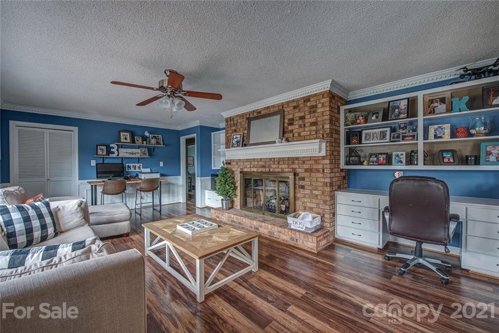 2103 Heavner Road Lincolnton, NC 28092 - Photo 11 of 25 a living room with furniture a fireplace and a large window