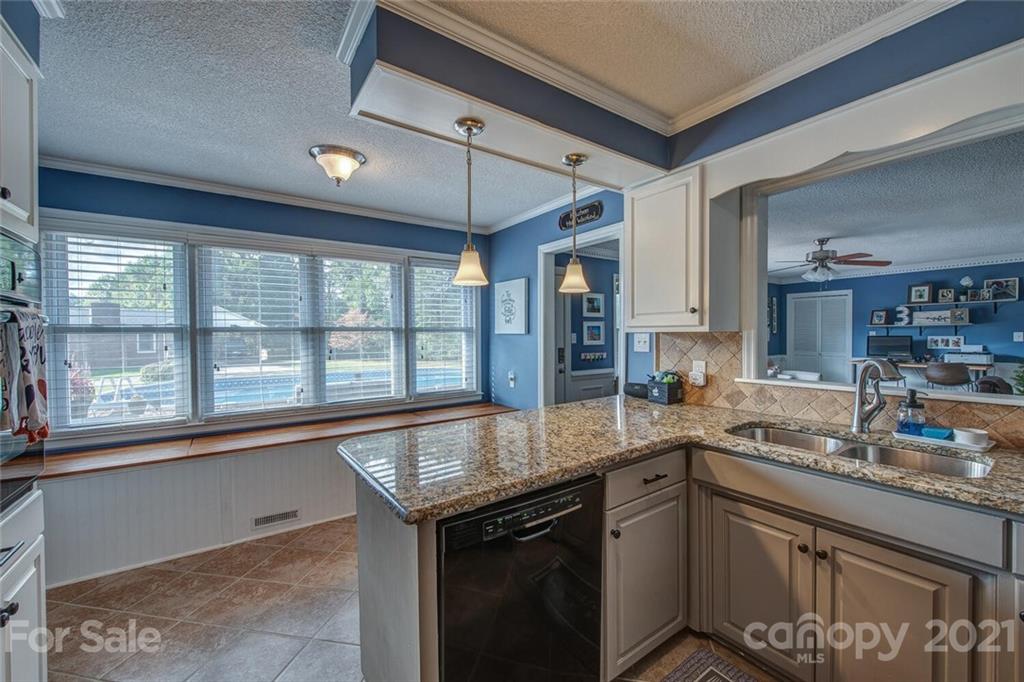 2103 Heavner Road Lincolnton, NC 28092 - Photo 15 of 25 a kitchen with a sink stove and cabinets