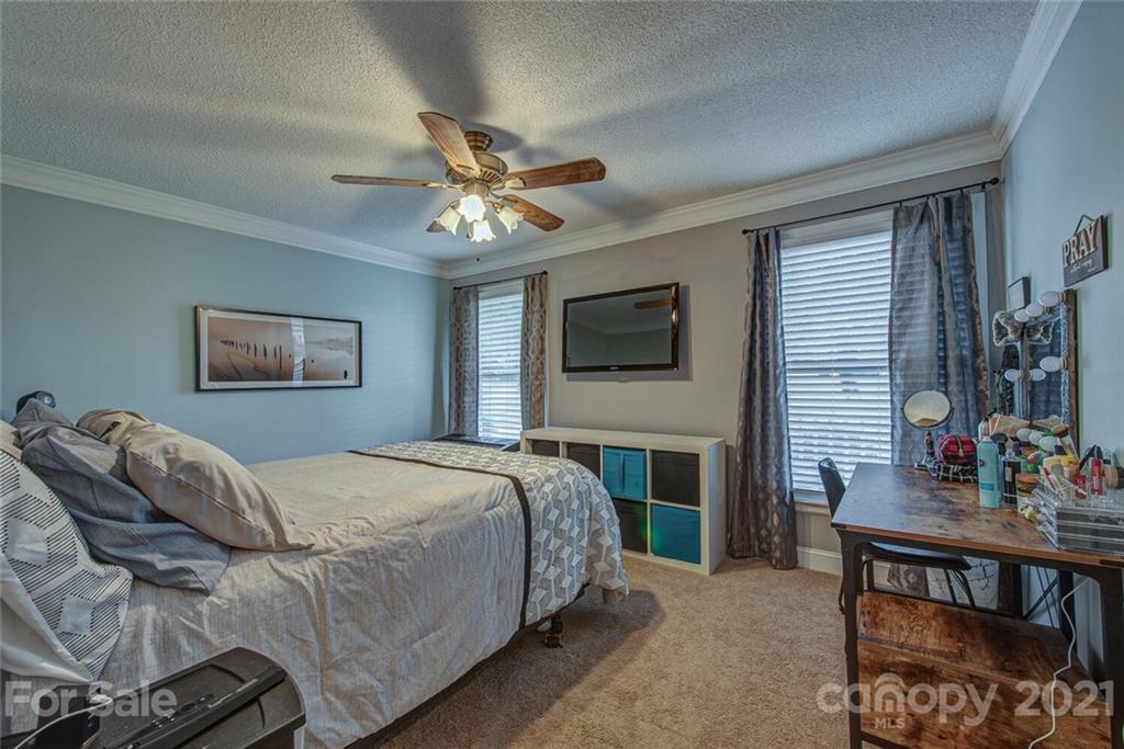 2103 Heavner Road Lincolnton, NC 28092 - Photo 17 of 25 a bedroom with a bed and a chandelier