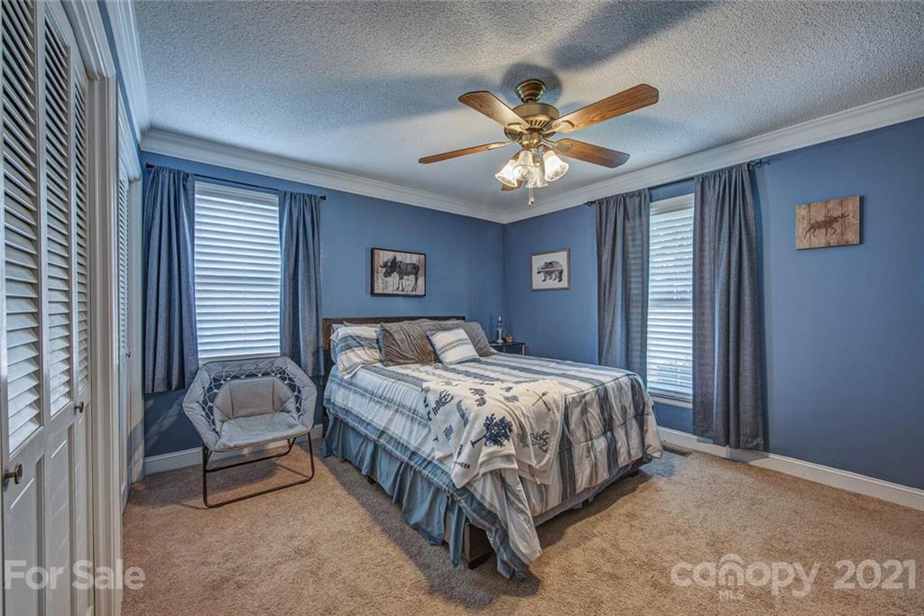 2103 Heavner Road Lincolnton, NC 28092 - Photo 18 of 25 a bedroom with a bed and a chandelier