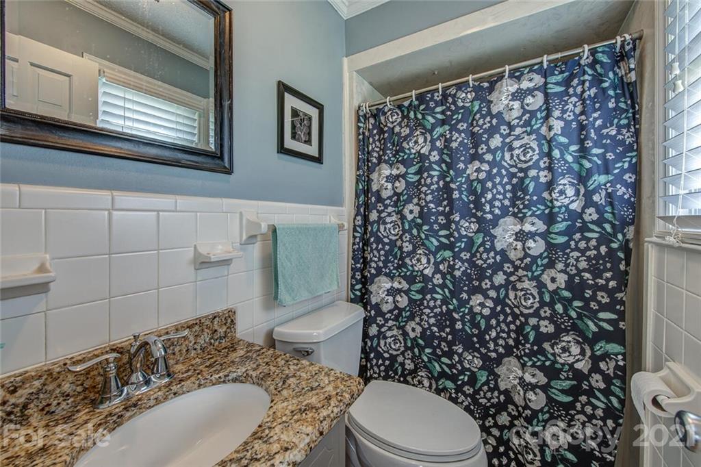 2103 Heavner Road Lincolnton, NC 28092 - Photo 21 of 25 a bathroom with a granite countertop toilet and a sink