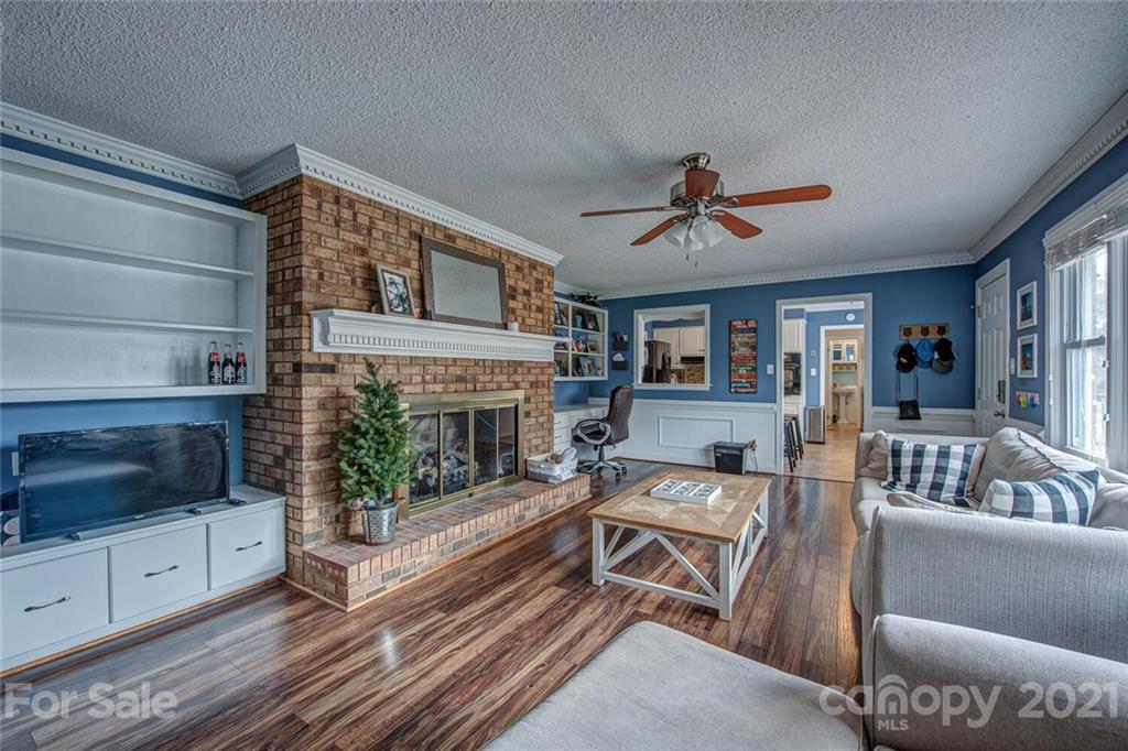 2103 Heavner Road Lincolnton, NC 28092 - Photo 10 of 25 a living room with furniture a flat screen tv and a fireplace