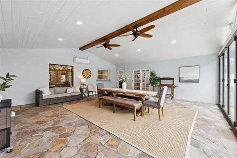 a living room with furniture and large windows