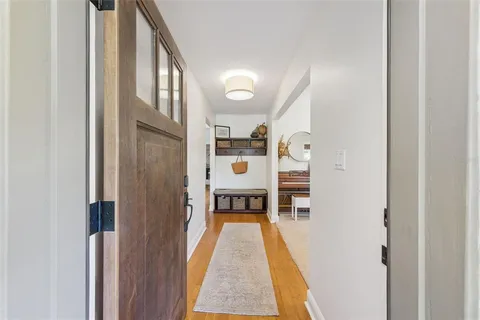 a living room with furniture and a piano