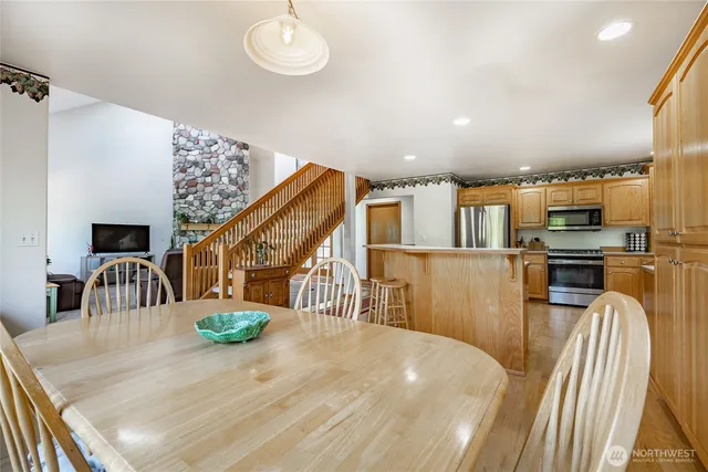 a view of a dining room with furniture a kitchen and chandelier