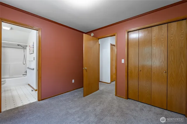 an empty room with bathroom view