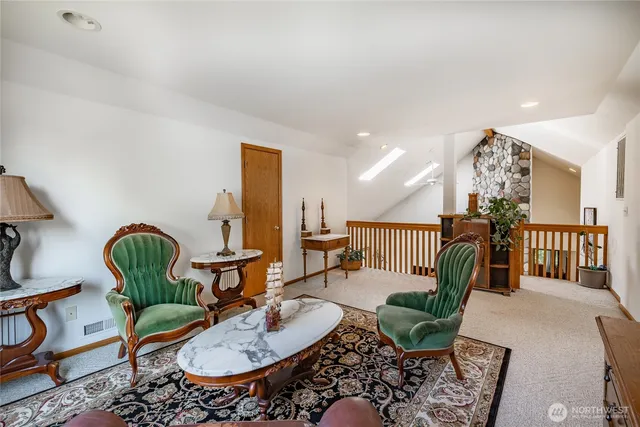a living room with furniture a rug and white walls