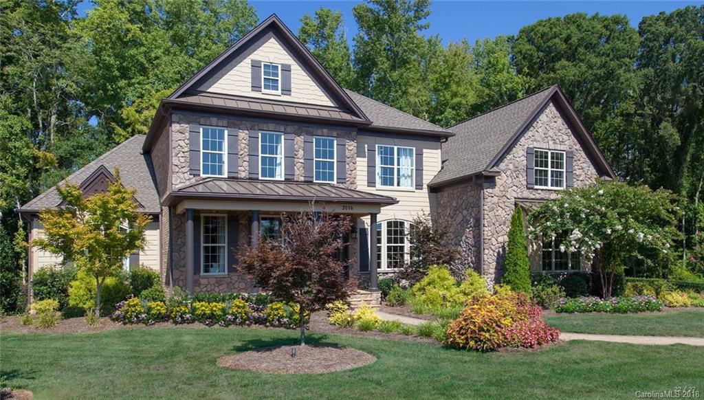 2016 Flowering Peach Road, Unit 68 Marvin, NC 28173 - Photo 1 of 14 a front view of house with a garden