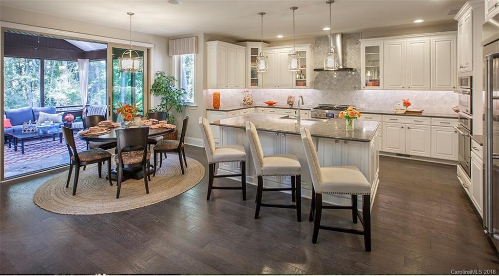 2016 Flowering Peach Road, Unit 68 Marvin, NC 28173 - Photo 2 of 14 a dining room with furniture a kitchen view and a chandelier