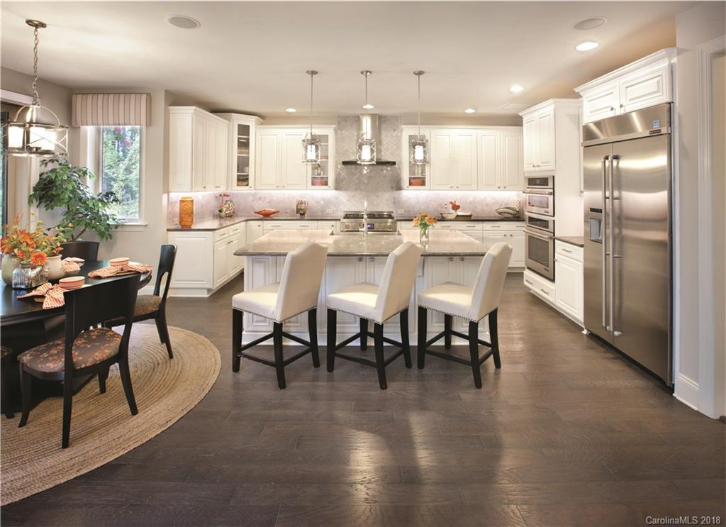 2016 Flowering Peach Road, Unit 68 Marvin, NC 28173 - Photo 3 of 14 a dining room with stainless steel appliances kitchen island granite countertop a dining table chairs and granite counter tops