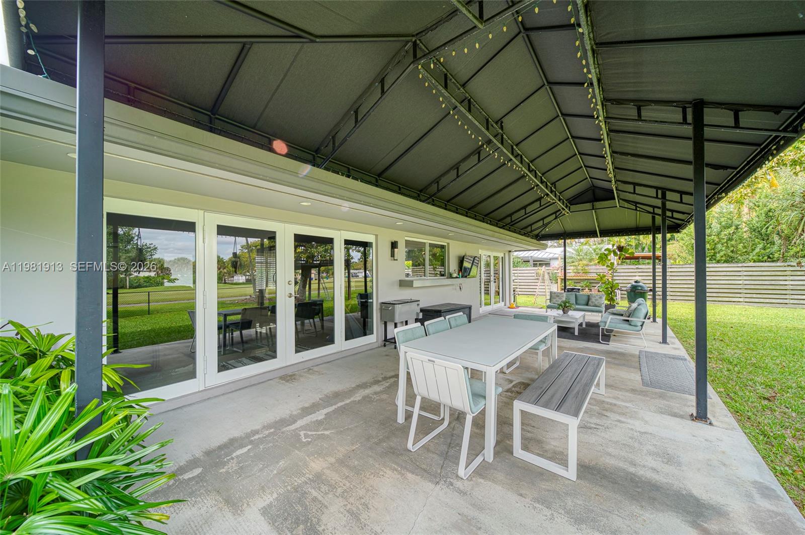 10131 Southwest 108th Street Miami, FL 33176 - Photo 17 of 21 a patio with table and chairs and potted plants