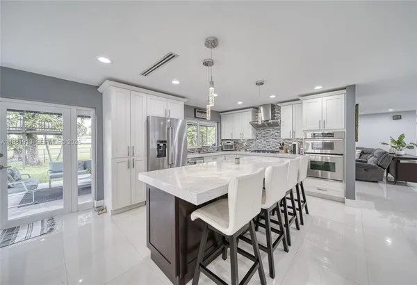 a kitchen with a stove and white cabinets