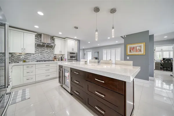 a living room with furniture a table and a large window