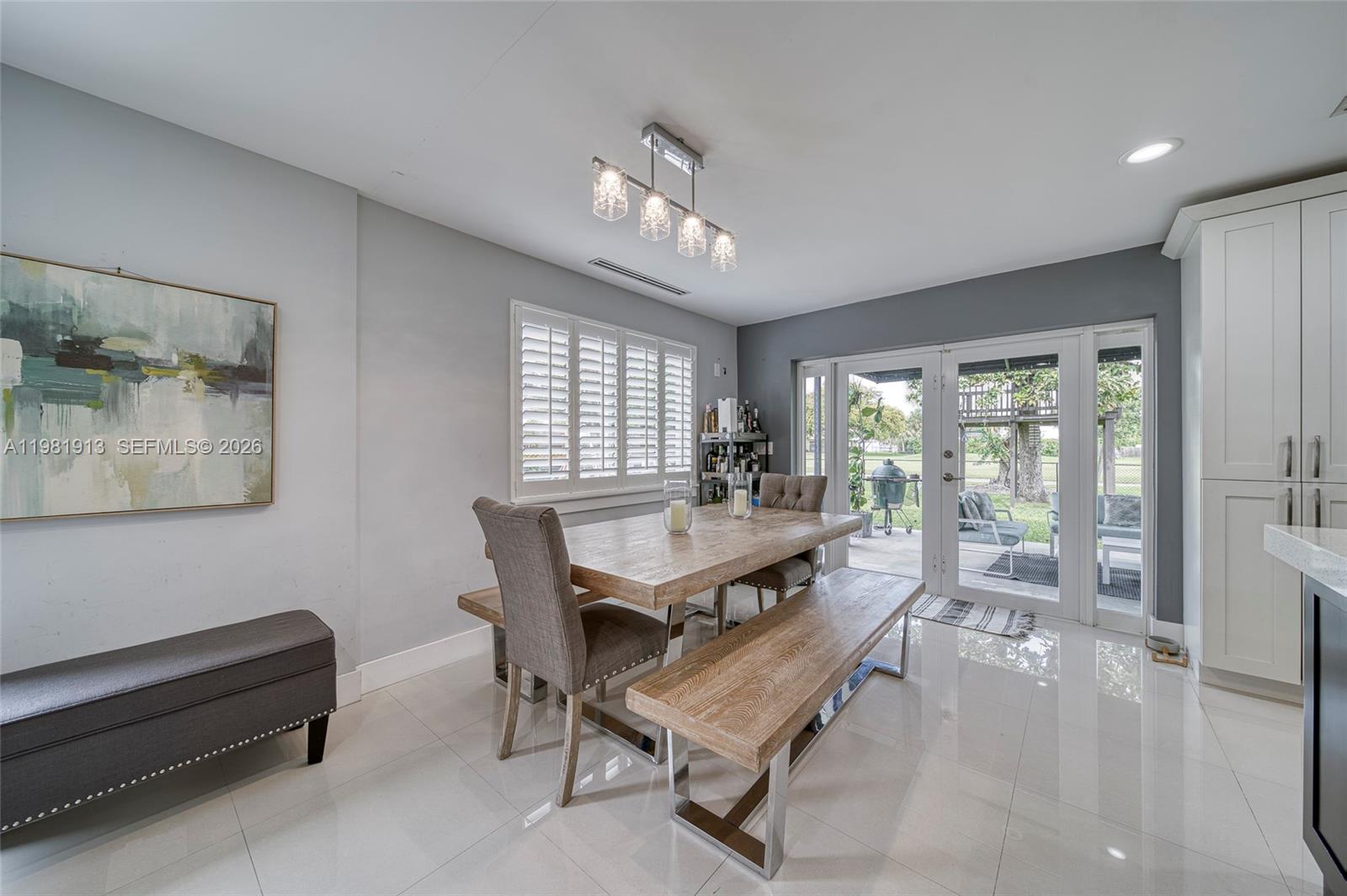 10131 Southwest 108th Street Miami, FL 33176 - Photo 9 of 21 a living room with furniture a table and a large window