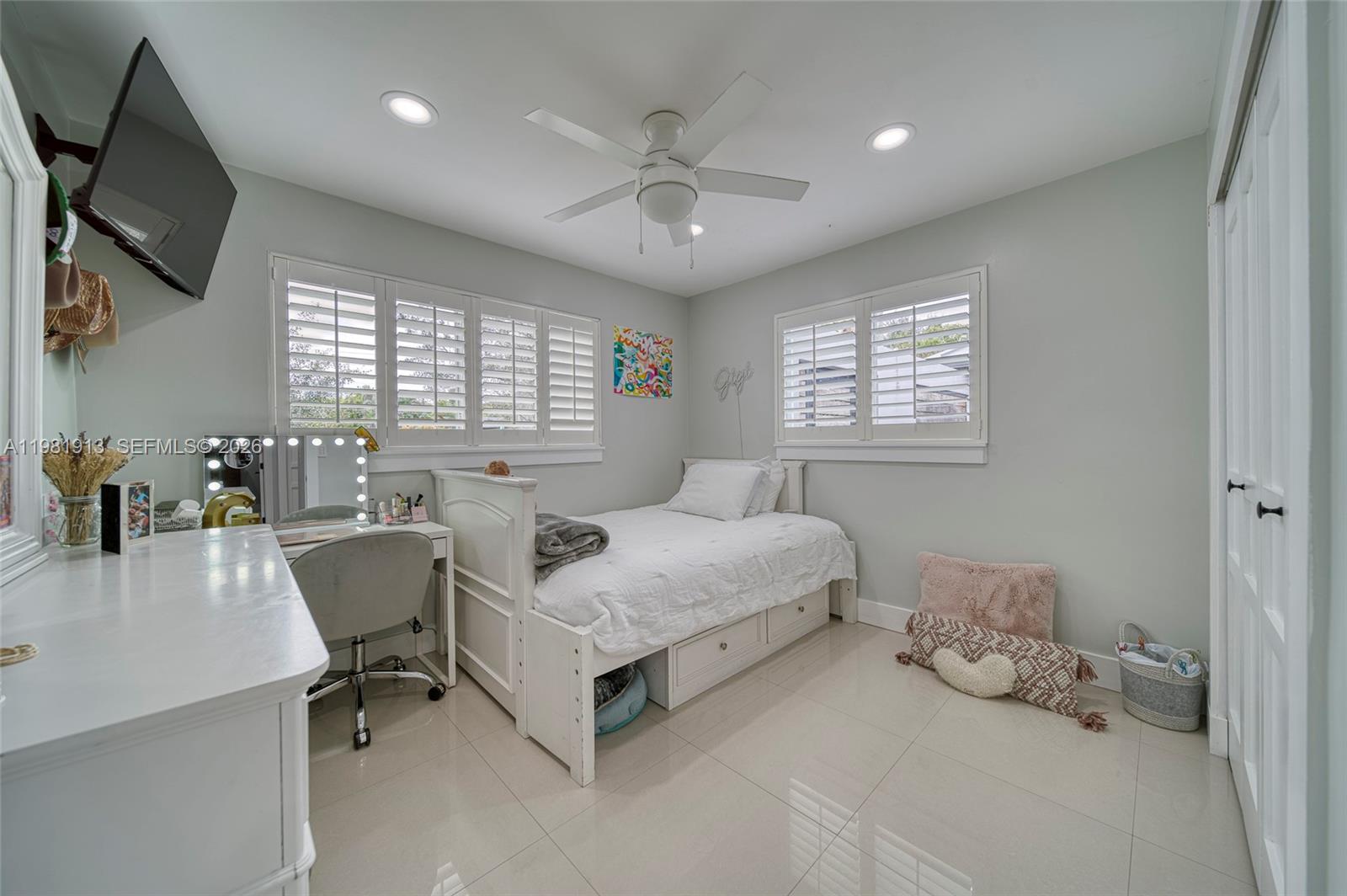 10131 Southwest 108th Street Miami, FL 33176 - Photo 10 of 21 a spacious bedroom with a bed and a table in it