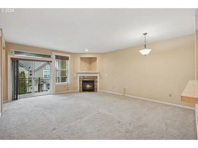 a view of an empty room with a fireplace