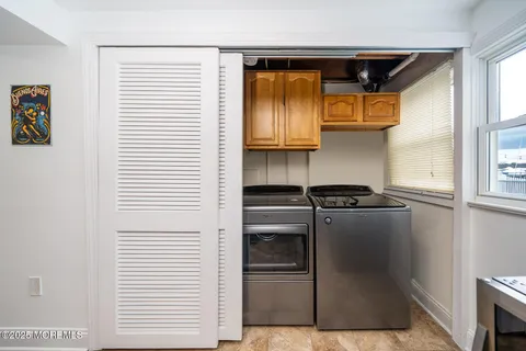 a kitchen with stainless steel appliances cabinets and a window