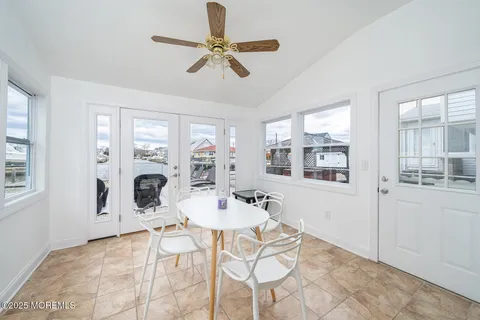 a living room with furniture kitchen view and a window