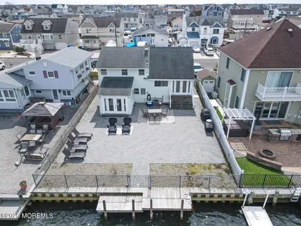 an aerial view of a house with large trees