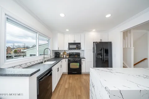 a kitchen with a stove a refrigerator and a sink