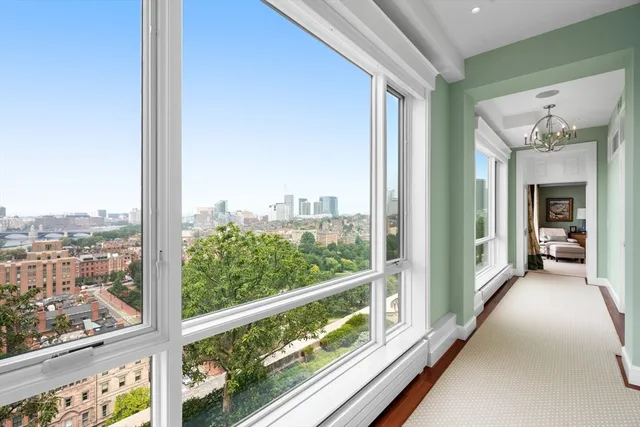 a living room with a large window vanity and a glass door shower