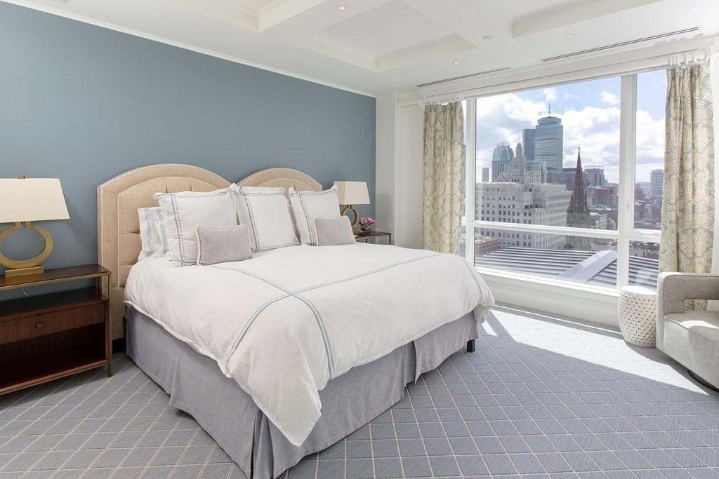 2 Commonwealth Avenue, Unit PH 3/4 Boston, MA 02215 - Photo 28 of 29 a spacious bedroom with two beds and a large window
