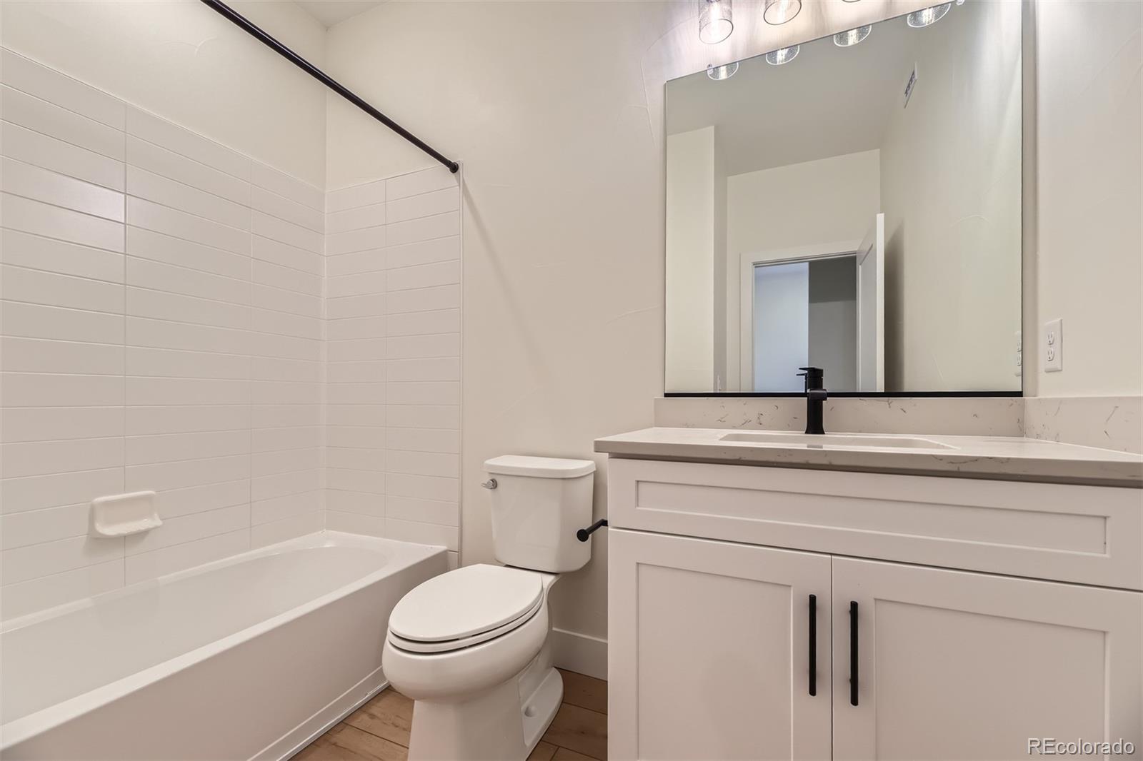 42966 Colonial Trail Elizabeth, CO 80107 - Photo 22 of 29 a bathroom with a sink a toilet and a bathtub