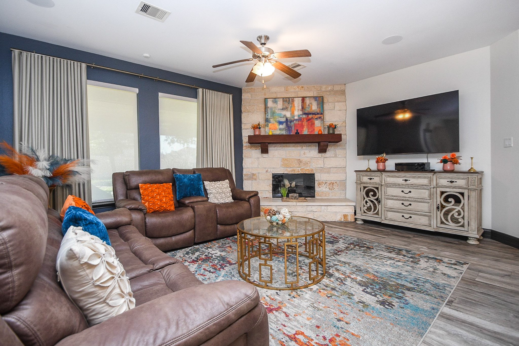 4331 Estes Ridge Lane Katy, TX 77493 - Photo 9 of 42 a living room with furniture a flat screen tv and a fireplace