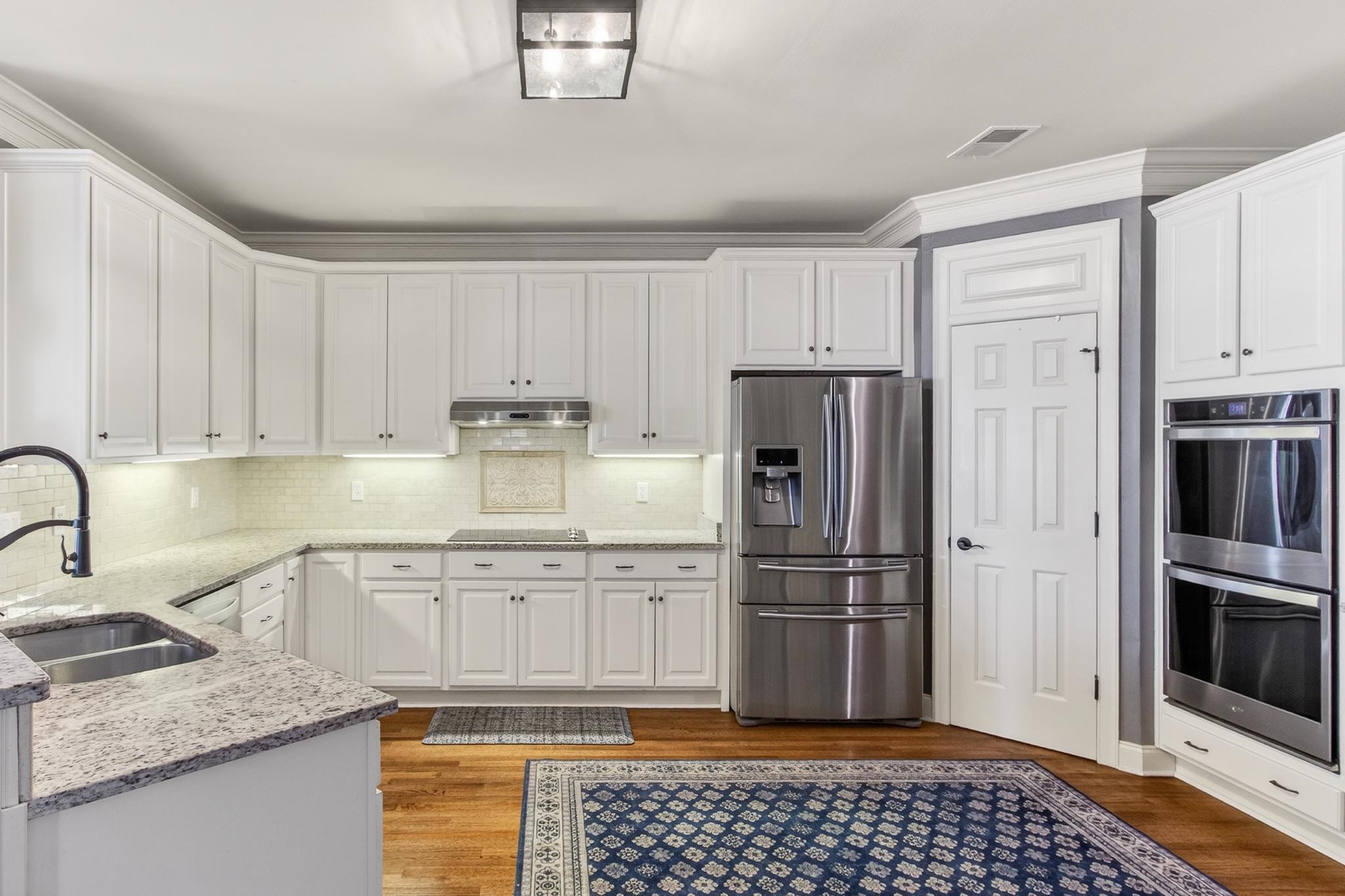 2283 Shrewsbury Run East Collierville, TN 38017 - Photo 30 of 40 a kitchen with granite countertop a refrigerator stove and sink