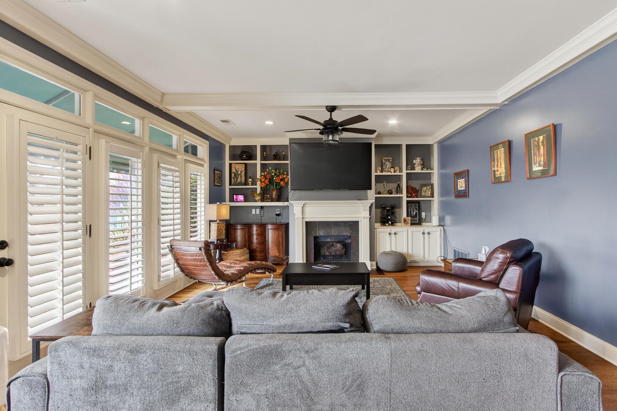 2283 Shrewsbury Run East Collierville, TN 38017 - Photo 33 of 40 a living room with furniture a fireplace and a flat screen tv