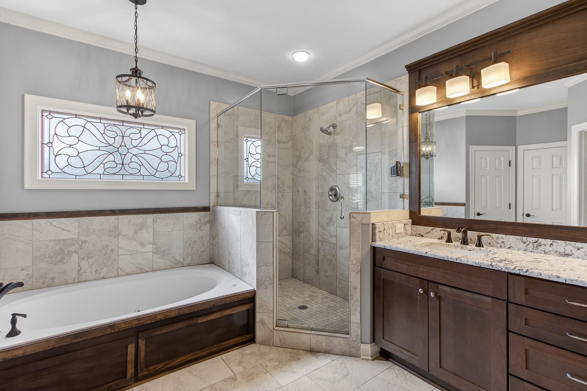 2283 Shrewsbury Run East Collierville, TN 38017 - Photo 40 of 40 a bathroom with a tub a sink and mirror