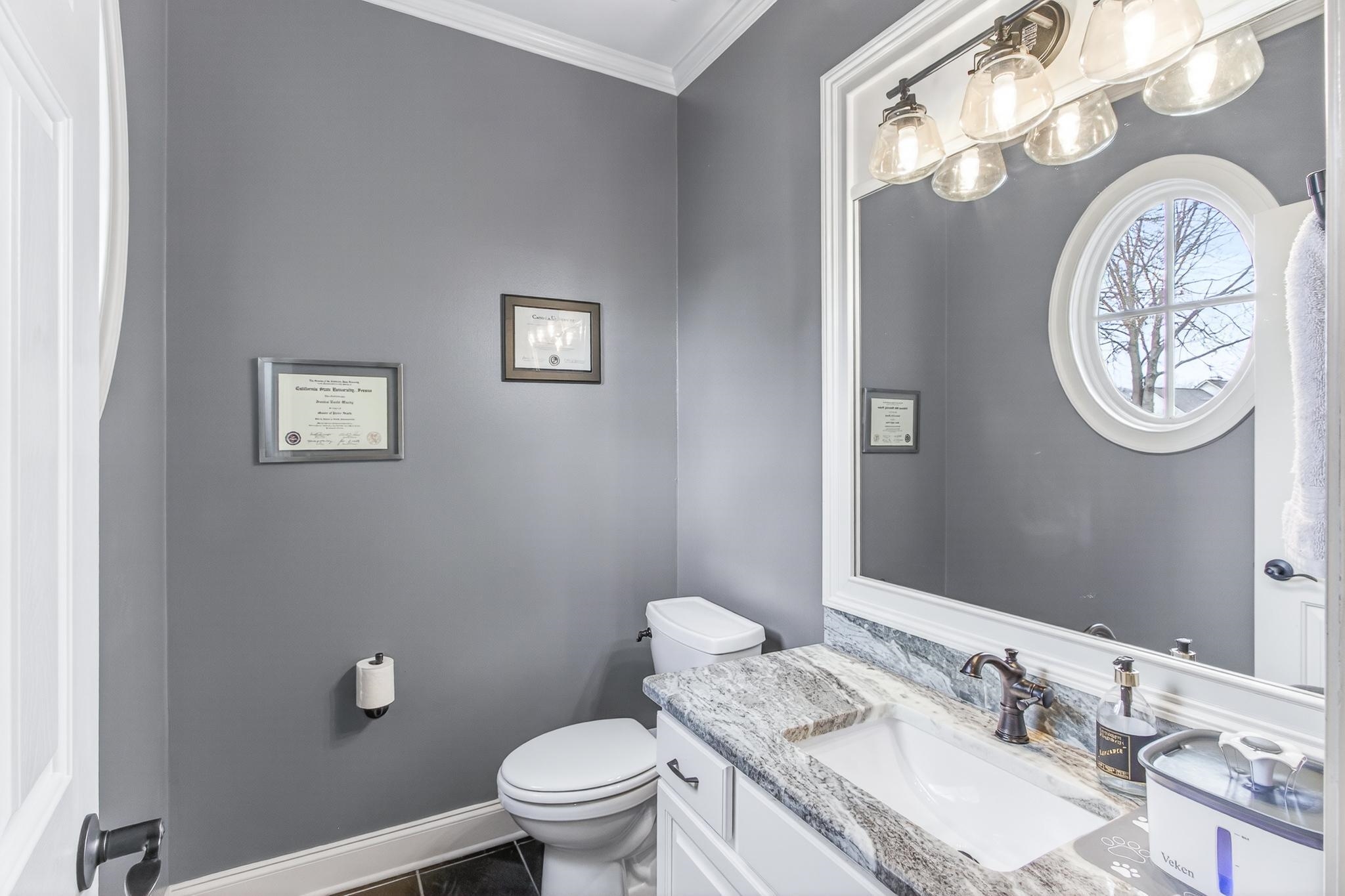 2283 Shrewsbury Run East Collierville, TN 38017 - Photo 5 of 40 a bathroom with a granite countertop toilet a sink and a mirror