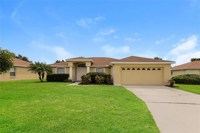 a view of a house with a yard and garage